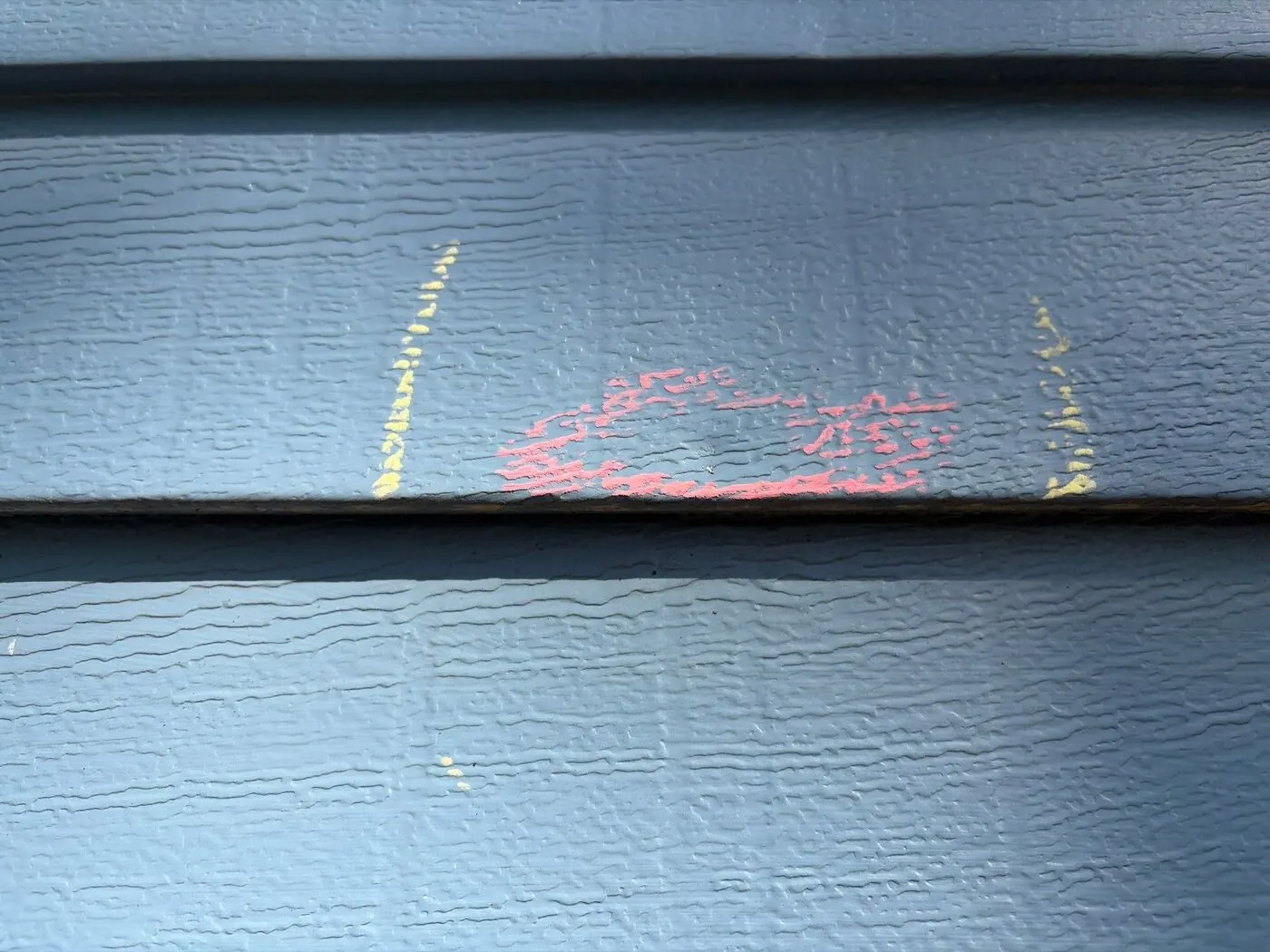 Aluminum siding: A dent marked between two seams