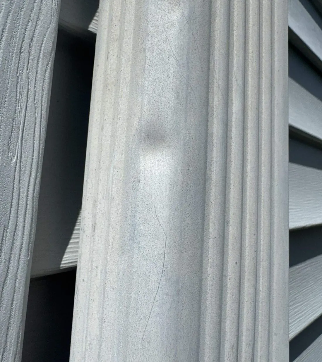 Hail dent in an aluminum downspout found during an inspection