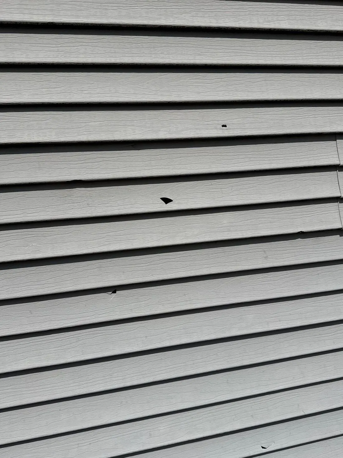 Vinyl siding: Holes punched through vinyl siding by hail